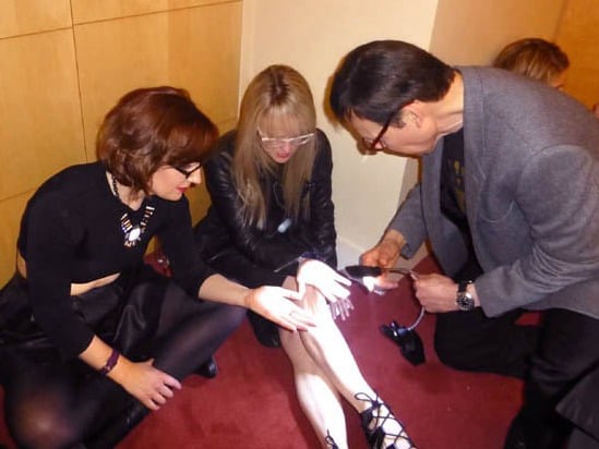Girls at a sweet 16 party getting palm readings.
