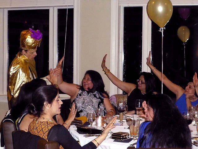A crowd of prom attendees get their palms read.