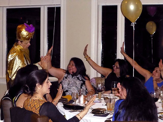 A crowd of prom attendees get their palms read.